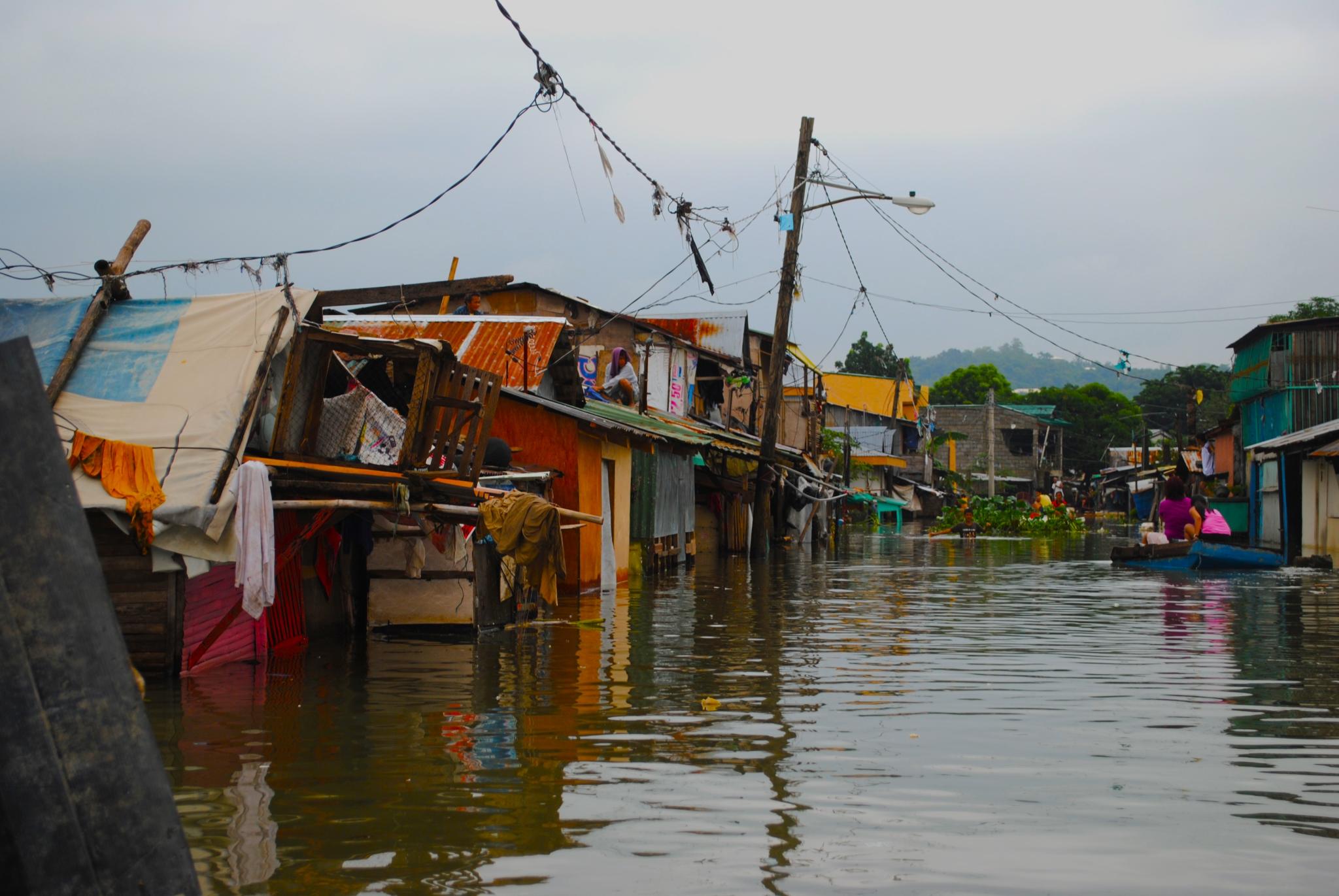 Poorer suburbs along the large Laguna lake near the capital Manila have been badly flooded after torrential rains.
