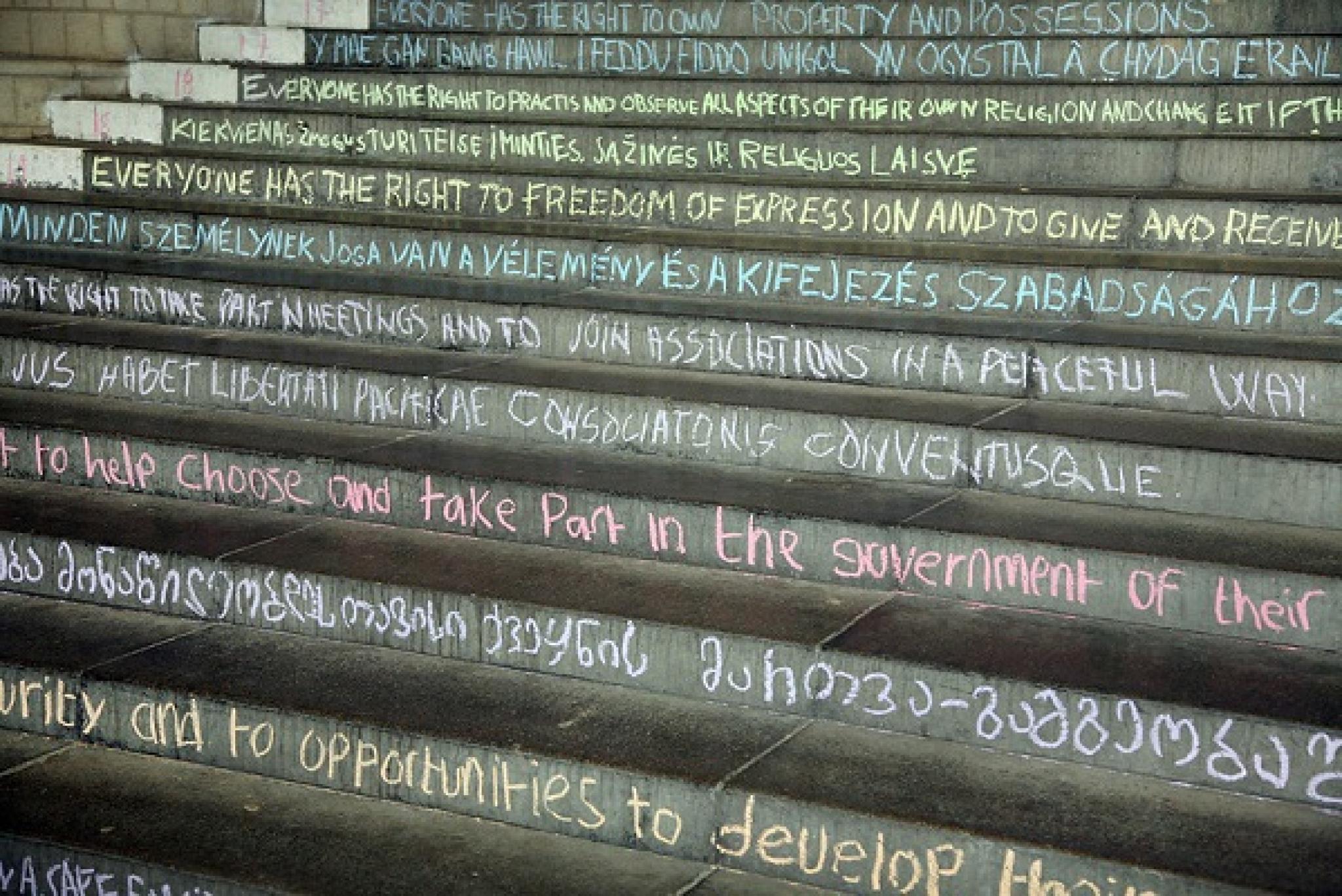 Image of the articles of the Universal Declaration of Human Rights chalked on the steps of University of Essex, by University of Essex at https://flic.kr/p/ifvFD5, free to use under CC BY 2.0 DEED licence 