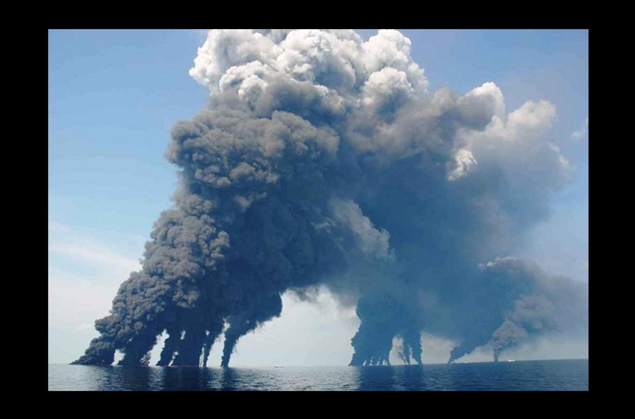Photo of smoke plumes from spill-response crews gathering and burning oil in the Gulf of Mexico, Deepwater Horizon Oil Spill, by Dr. Oscar Garcia (Florida State University), used under CC BY-NC-SA 2.0 licence.