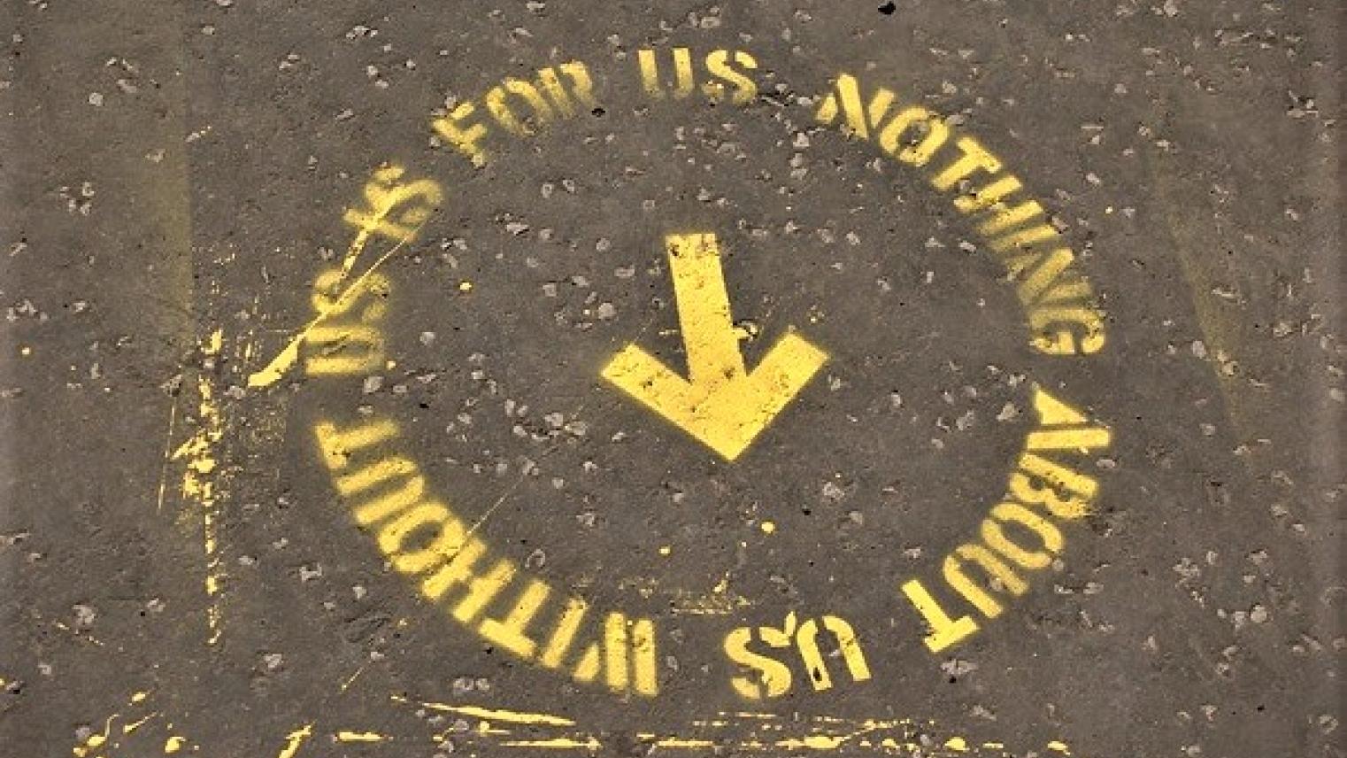 Image of street art stencil: “Nothing about us without us is for us” from public art event of the same name in Glasgow, Scotland, by t s Beall and many others from https://flic.kr/p/dv5FgK, used under CC BY-NC-SA 2.0 DEED licence