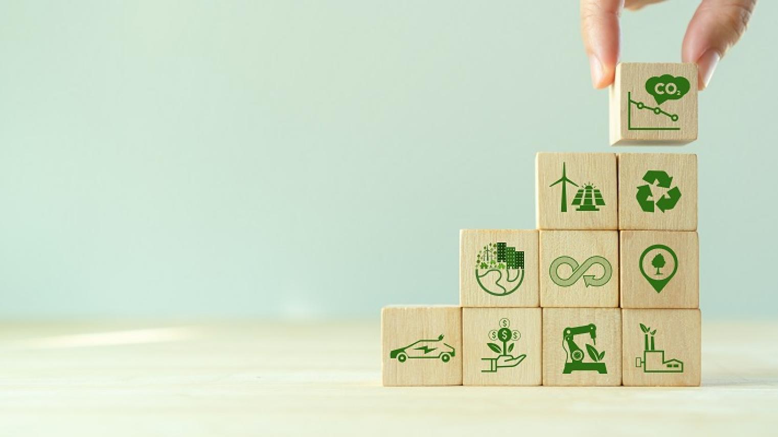 Image of hand stacking cubes with decarbonisation icons by Parradee, from Adobe Stock images, used under Educational Licence 