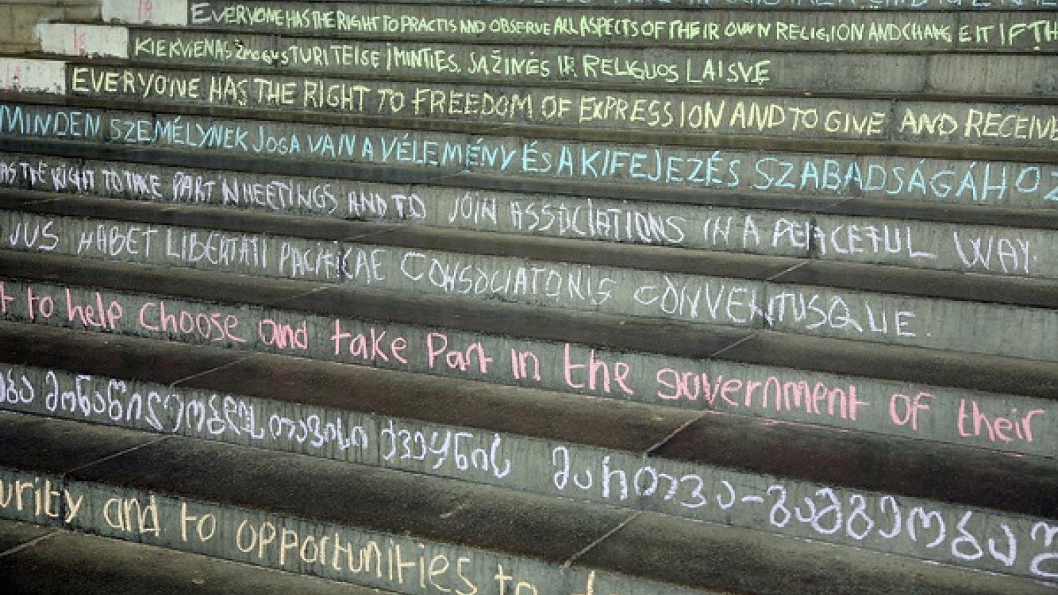 Image of the articles of the Universal Declaration of Human Rights chalked on the steps of University of Essex, by University of Essex at https://flic.kr/p/ifvFD5, free to use under CC BY 2.0 DEED licence 