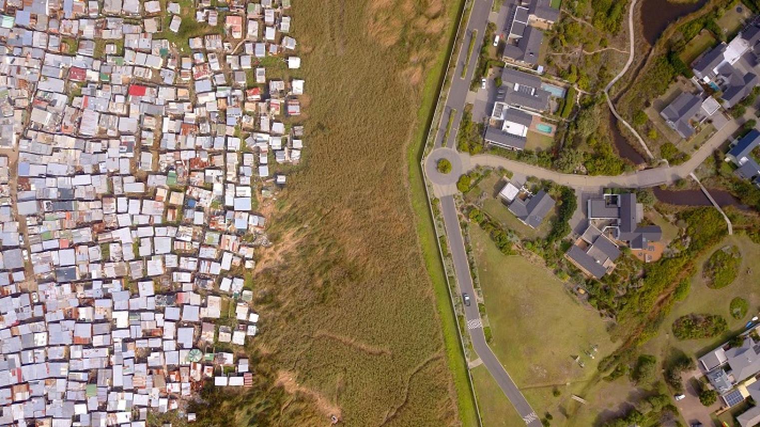 Aerial shot of township and rich suburb divided by wall, South Africa, https://stock.adobe.com/au/images/aerial-poor-township-and-rich-suburb-in-south-africa/791664914 , by fivepointsix, used under Adobe Education License 