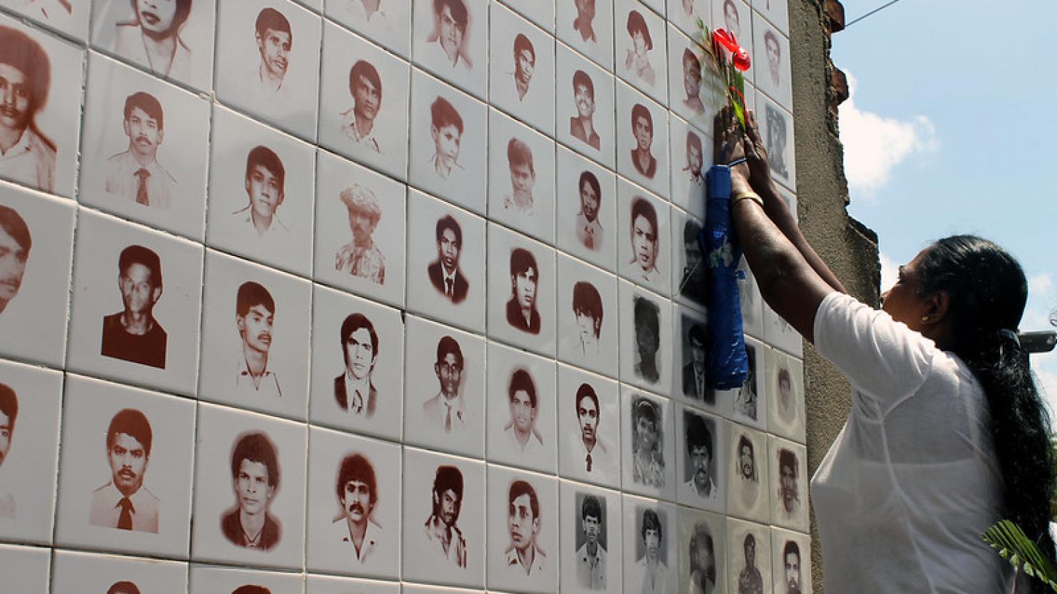 Image of woman grieving at memorial wall of missing persons in Sri Lanka https://flic.kr/p/h1KJ7Y, by citizen journalists Vikalpa, Maatram and Groundviews, used under CC BY 2.0 license.