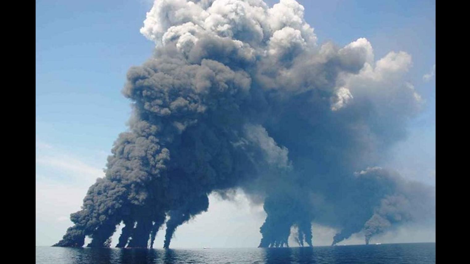 Photo of smoke plumes from spill-response crews gathering and burning oil in the Gulf of Mexico, Deepwater Horizon Oil Spill, by Dr. Oscar Garcia (Florida State University), used under CC BY-NC-SA 2.0 licence.